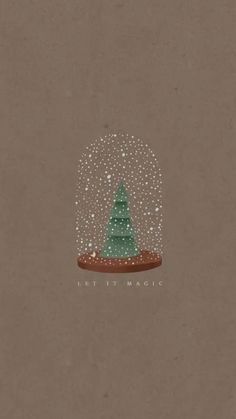 a christmas tree under a snow globe with the words let it magic written on it