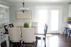 the dining room table is set with four chairs, and there are no people around it