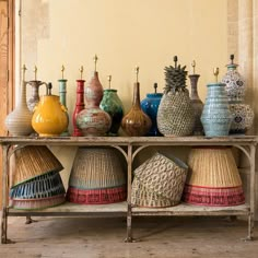 many different vases are sitting on a shelf