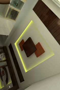 the interior of a modern home with wood accents and lighting on the ceiling, along with decorative wall hangings