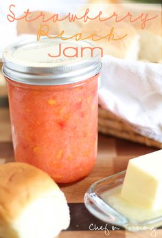 there is a jar of jam and some bread on the table