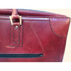 a red leather bag with two zippers on it