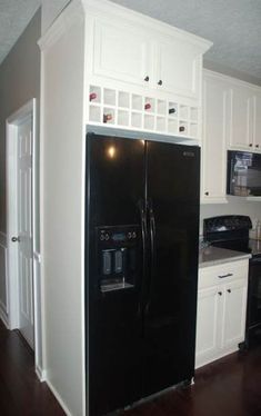 a black refrigerator freezer sitting inside of a kitchen