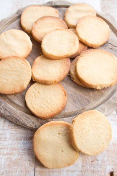 a wooden platter filled with cookies on top of a table