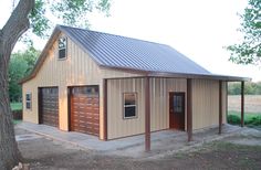 a two car garage is shown in front of a tree