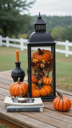 a lantern and some pumpkins on a table