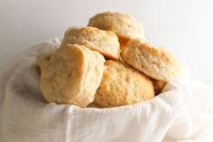 some biscuits are in a white bowl on a table