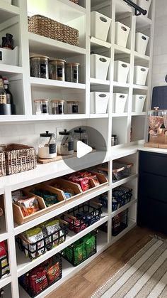 an organized pantry with white shelving and lots of food in baskets on the shelves