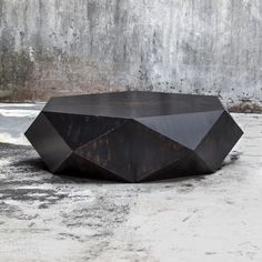 a black table sitting on top of a cement floor