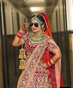 a woman in a red and gold bridal outfit