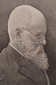 an old black and white photo of a man in glasses with a beard wearing a suit