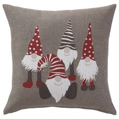 three gnomes on a gray pillow with red and white polka dots