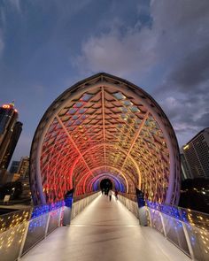 the walkway is lit up with colorful lights