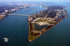 an aerial view of a large island in the middle of water with a bridge crossing over it