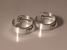 This Promise? Promise. Pinky Promise Ring Set is the perfect way to make a special vow to someone you love. Crafted from quality materials, the set features two matching rings, making it ideal for couples who want to express their commitment to one another. Show your devotion with this timeless pinky promise ring set. Product Details: Materials: Aluminum, Sterling Silver, Fine Silver, 14k Gold Filled Color: Silver, Gold, Rose Gold Size: 6mm Two Matching Rings You will receive two hand-stamped ri Adjustable Sterling Silver Couple Rings For Proposal, Silver Couples Promise Ring, Sterling Silver Personalized Rings For Proposal, Adjustable Couples Promise Rings, Engraved Open Ring Couple Rings For Promise, Adjustable Personalized Rings For Proposal, Personalized Adjustable Ring For Proposal, Silver Couples Jewelry For Proposal, Adjustable Couple Rings For Proposal