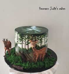 there is a cake decorated with deer and trees