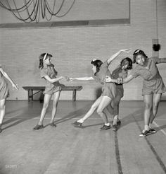 four young women are dancing in an old photo