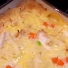 a casserole dish with chicken and carrots in it