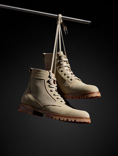 Front angled view of Ojai City Boot in Natural suede and canvas from AETHER Apparel hanging from shoelaces on wire. Spring Tees, Fabric Boots, Life Well Lived, Leather Heels, Heavy Duty, Combat Boots, Timeless Fashion, Shoes Mens, Leather Jacket