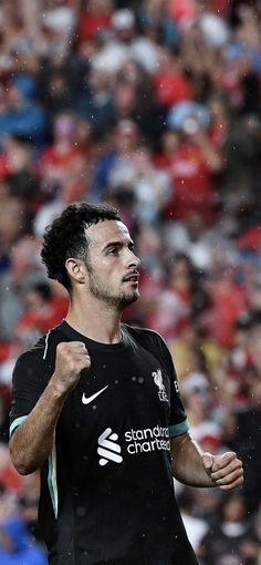 a soccer player is running in the rain