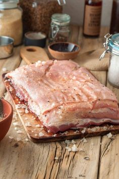 a piece of meat sitting on top of a wooden cutting board