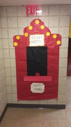 a red and black door with yellow dots on it in the middle of a hallway