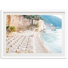 an image of a beach with tables and chairs on the sand next to the water