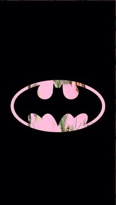 a batman symbol with pink flowers and leaves on the bottom, in front of a black background