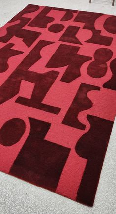 a red rug with black and white letters on it