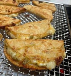 several pieces of food sitting on top of a metal grill grates and cooling rack