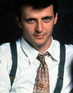 a man wearing suspenders and a tie