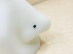 a close up view of a white object with black stars on it's face