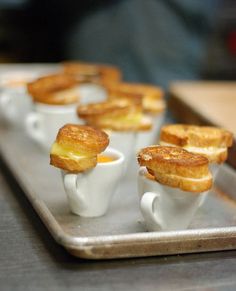 small cups filled with food sitting on top of a metal tray