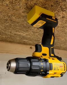 a cordless drill is attached to the ceiling