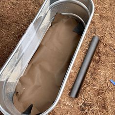 an empty metal container sitting on the ground