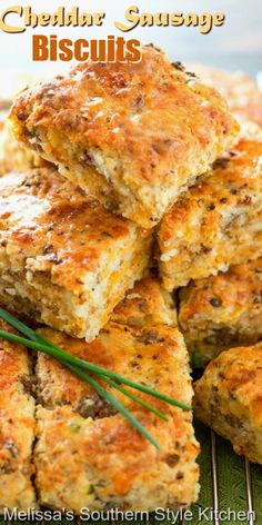 cheddar sausage biscuits stacked on top of each other with rosemary sprigs