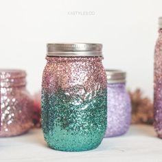 three jars with different colored glitters on them