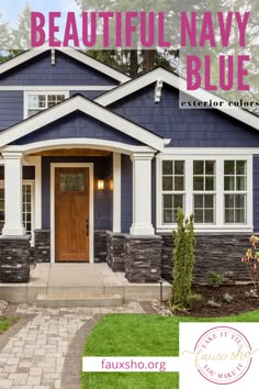 a beautiful navy blue house with white trim and brick walkway leading to the front door