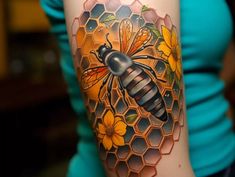 a woman with a tattoo on her arm has a honeybee and flowers in it