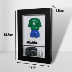 a shadow box with a soccer jersey in it