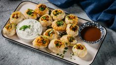 small appetizers on a plate with dipping sauce