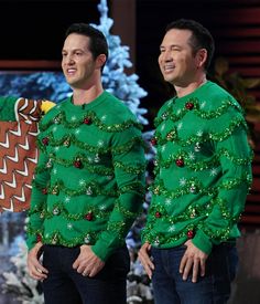 two men in ugly christmas sweaters standing next to each other