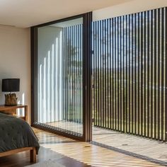 a bedroom with sliding glass doors leading to the outside