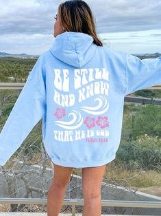 Express a Message of Faith with this cute and unique Coconut Girl Be Still And Know Hoodie! This Beachy Christian Surf Style Hibiscus Hoodie Sweatshirt is super comfy! Size up for a Trendy Oversized Look! SHIPS FREE! SIZING TIPS: Size up 2-3 sizes from your "usual size" to get the "Oversized" Look! (2 sizes up is most common, and 3 sizes up is more dramatic) For a "relaxed fit" order your "usual size". When in doubt, lay your favorite fitting Sweatshirt flat and measure armpit to armpit and comp Casual Light Blue Hoodie With Letter Print, Light Blue Hooded Sweatshirt With Letter Print, Light Blue Oversized Casual Hoodie, Oversized Light Blue Casual Hoodie, Casual Oversized Light Blue Hoodie, Cute Hoodies, School Fit, Be Still And Know, Coconut Girl