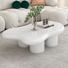 a white coffee table sitting on top of a carpeted floor next to a couch