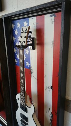 an electric guitar is displayed in a shadow box with the american flag painted on it