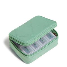 a mint green case with four compartments filled with money