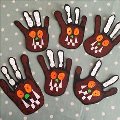 five handprints made to look like turkeys with carrots on their fingers