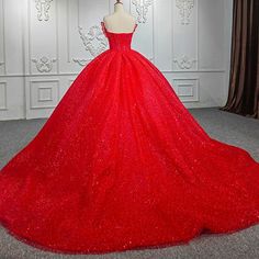 Radiate glamour and confidence in the Quinceañera Ball Gown Red Sleeveless Sequined Dress. This strapless ball gown features a sweetheart neckline that beautifully accentuates the bust and shoulders, while the sleeveless design offers a timeless and elegant silhouette. It is crafted from luxurious sequin fabric in a rich red hue, making you the center of attention. The intricate beading and sequined embellishments add depth and sparkle, ensuring you shine like a star throughout the night. The vo Red Sleeveless Dress For Prom, Red Sleeveless Evening Dress, Red Ball Gown For Banquet, Red Strapless Ball Gown With Fitted Bodice, Red Sleeveless Ball Gown With Fitted Bodice, Red Ball Gown With Sweetheart Neckline And Sweep Train, Red Ball Gown With Sweep Train For Evening, Red Carpet Evening Dress With Fitted Bodice, Red Sleeveless Prom Dress