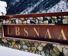 there is a sign that says libsnaa on the side of a stone wall